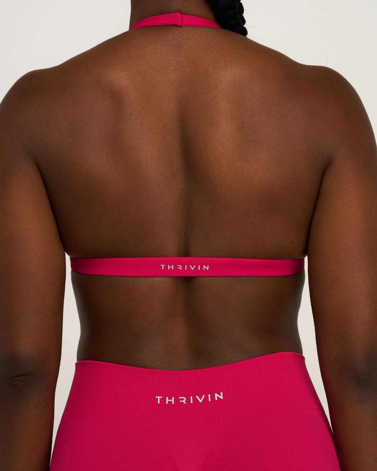 Elevate Sculpting Seamless V-Neck Halter Bra in Strawberry, back close-up of band with THRIVIN logo