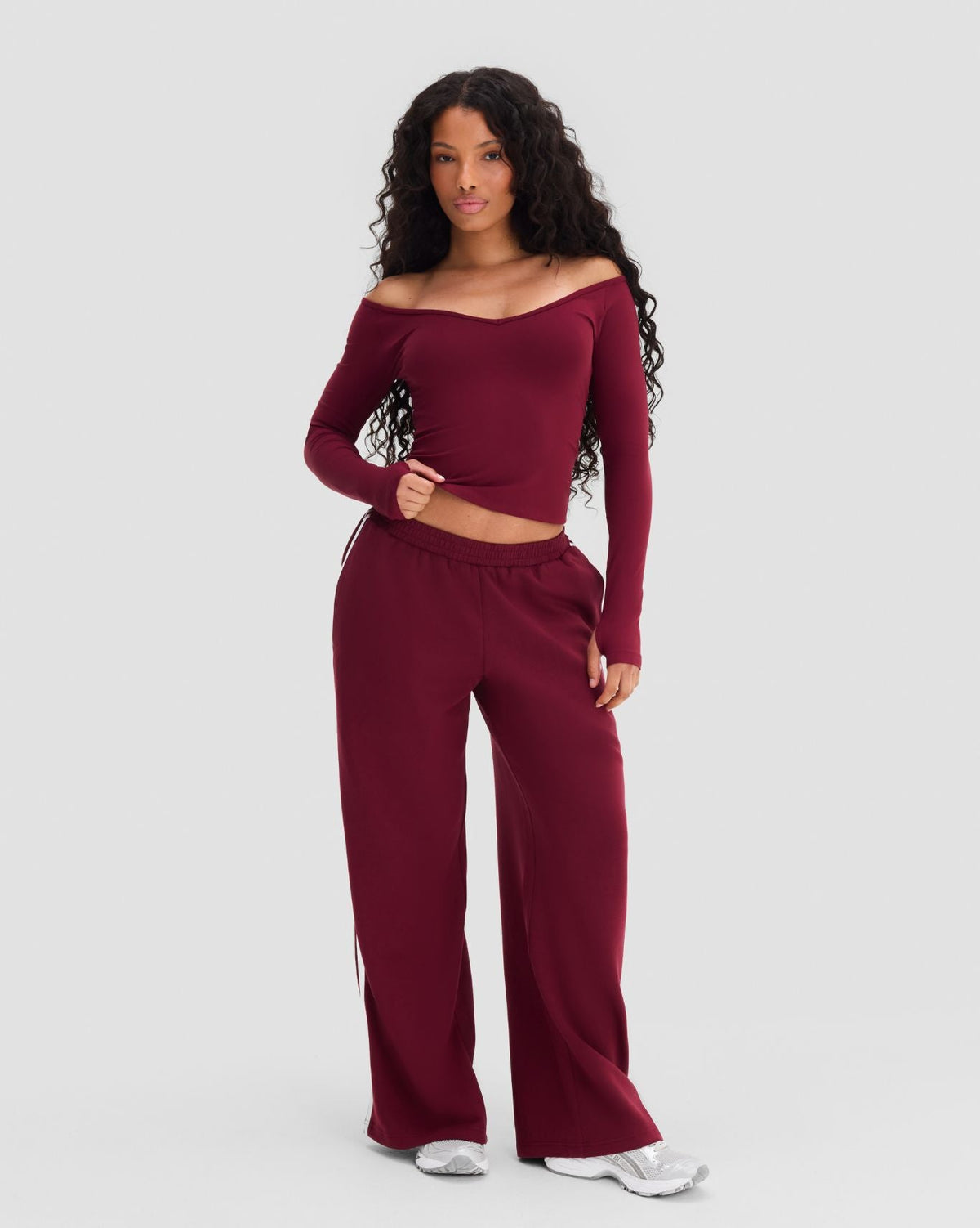 Elevate Sculpting Seamless V-Neck Top in Fine Wine Red, full-length front view styled with wide leg pants