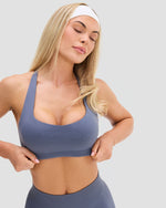 Elevate Sculpting Medium Impact Multiway Bra in Steel Blue, close-up of scoop neckline and wide underband in sculpting knit