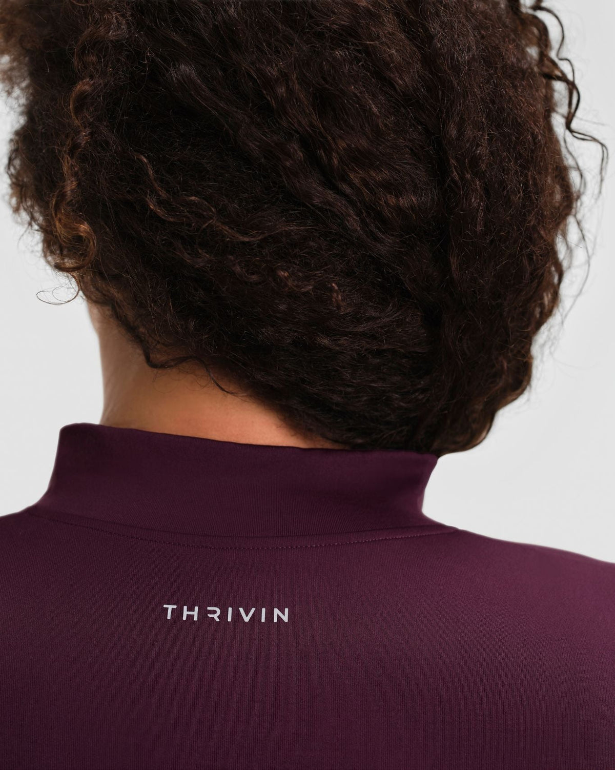 Elevate Compression Long Sleeve Jacket in Winter Plum Red, back close-up of stand collar and Thrivin logo
