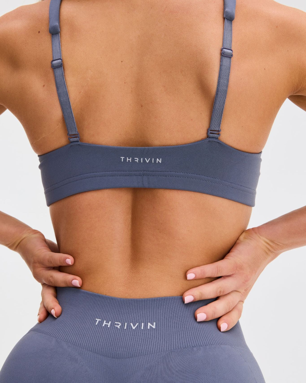 Elevate Sculpting Medium Impact Multiway Bra in Steel Blue, back close-up of straight straps, sliders and Thrivin logo band