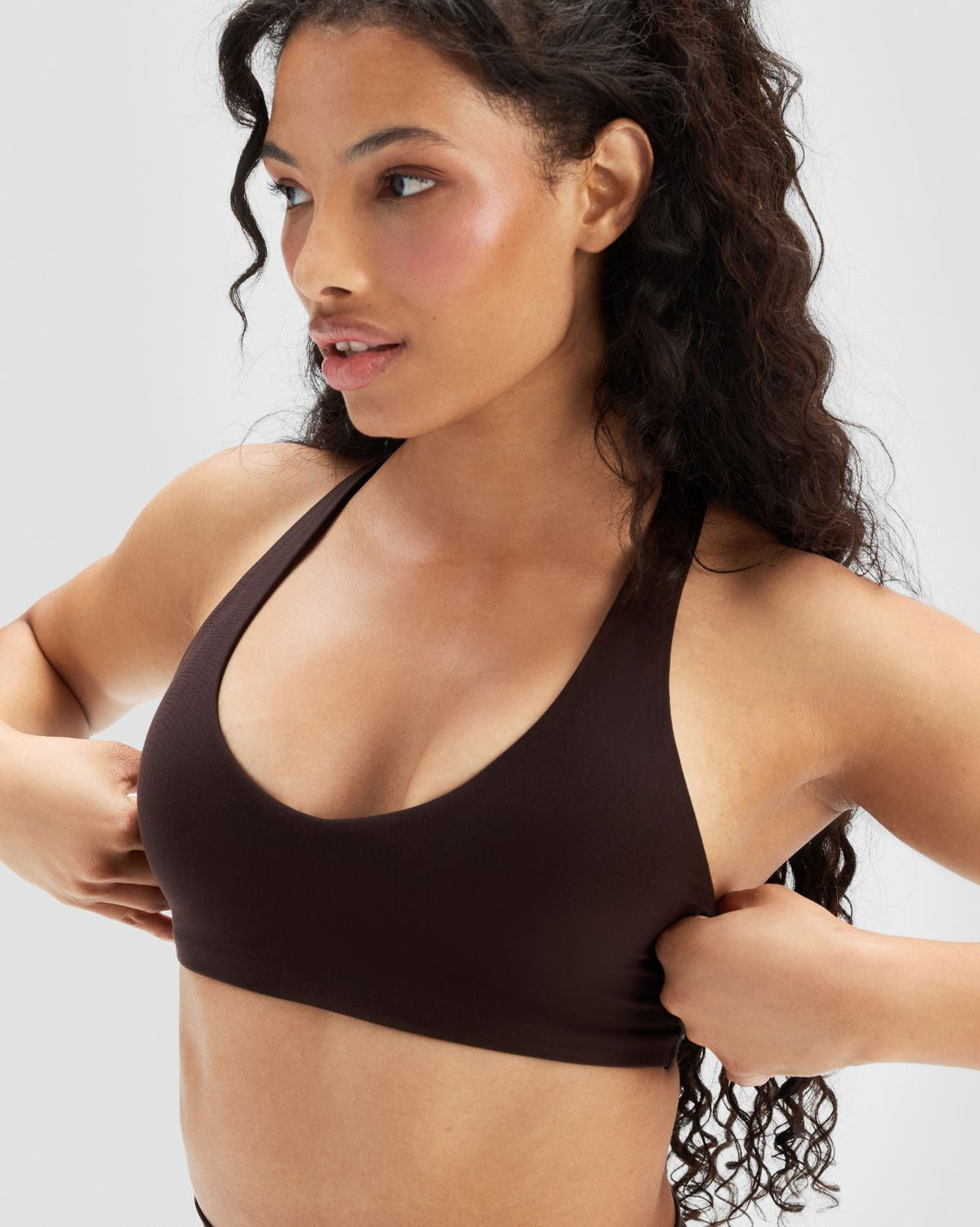 Essence Racer Back Sports Bra in Coffee Brown, three-quarter front close-up of scoop neckline and soft, stretchy fabric