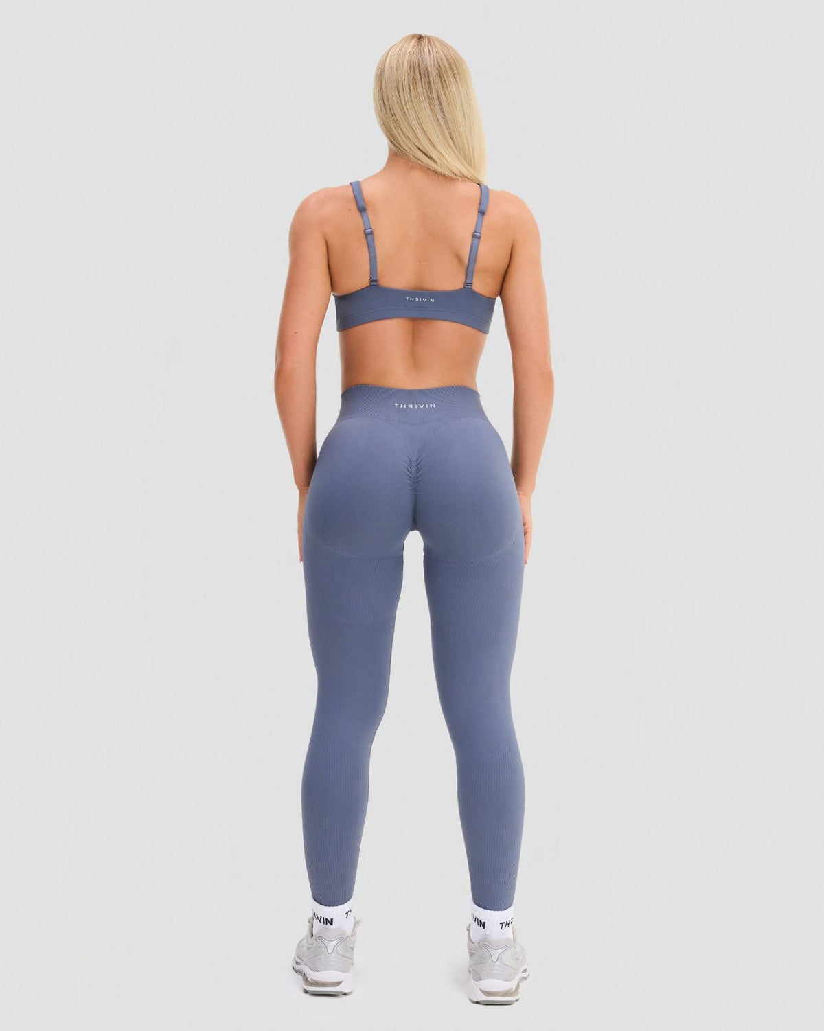 Elevate Sculpting Mid Waist Scrunch Leggings in Steel Blue, full-length back view of scrunch seam and Thrivin logo waistband