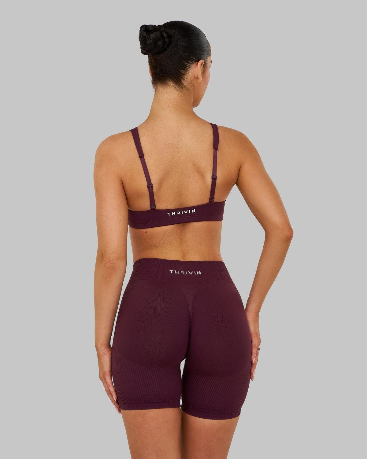 Elevate Sculpting Medium Impact Multiway Bra in Winter Plum Red, back view styled with shorts