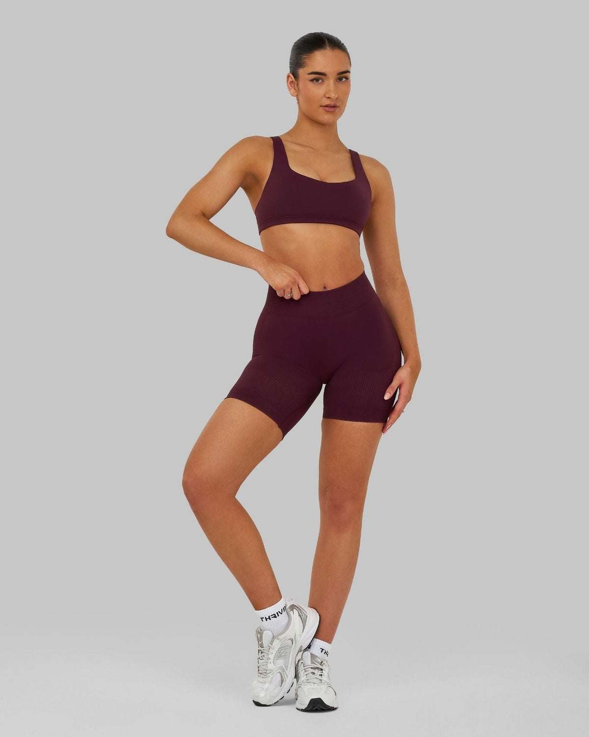 Elevate Sculpting Medium Impact Multiway Bra in Winter Plum Red, full-length front view with sneakers