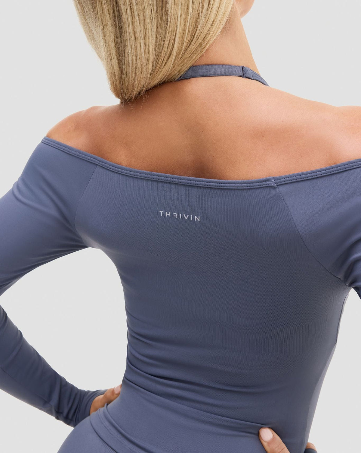 Elevate Sculpting Seamless V-Neck Top in Steel Blue, back close-up of off-shoulder neckline and Thrivin logo, seamless fabric